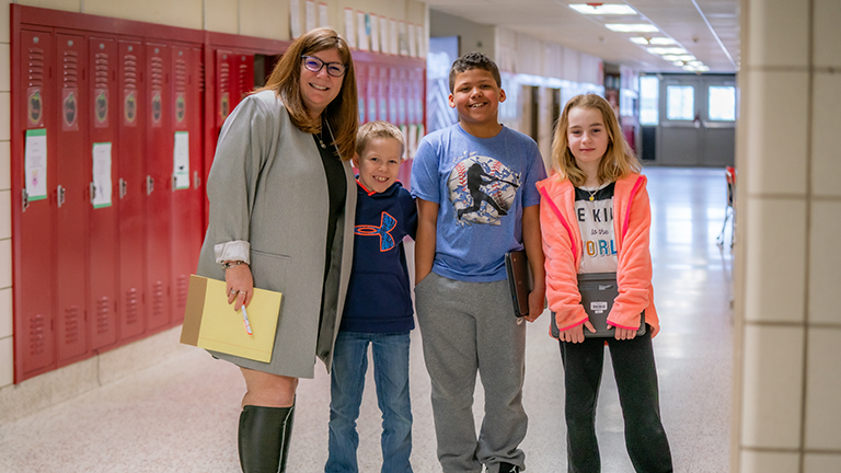 Students and teacher smiling